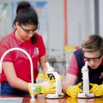 IGCSE students looking through microscopes